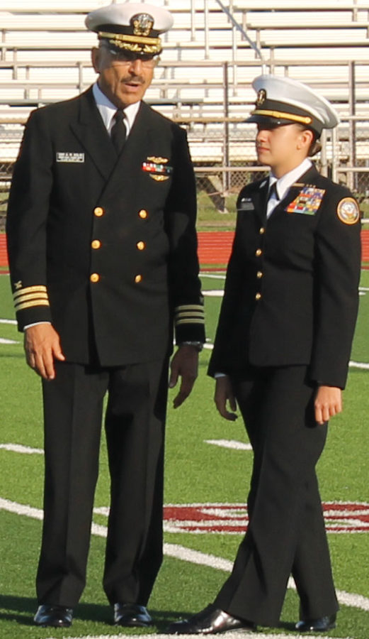 Commander Armando Solis and senior Mallory Dunn talk at the Hornet stadium before an inspection on March 22. 