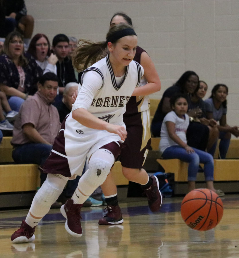 Senior Meredith Marcum brings the ball up the court against Tuloso- Midway on Feb. 20 in the  third round of the playoffs. The Hornets won, 58-33.