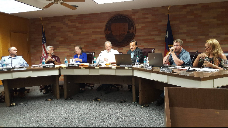 The school board prepares for the meeting held on July 26. Members (from left to right) : Jeff Rank, Jim Needham, Shirley Thornton, Steve Ellis, Michael Morgan, Brian Grunberg and Jennifer Welp.