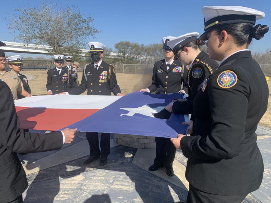 Members of both color guards hold the Texas flag while sophomore Hannah Holbrooks cuts out the star. 
From Left to Right: Guadalupe Armijo-Cruz, Estrella Reyna, Henry Stanley, Hannah Leclear, Jacob Cisneros, Izabella Perez, Hannah Holbrooks, Kyra Volkman
