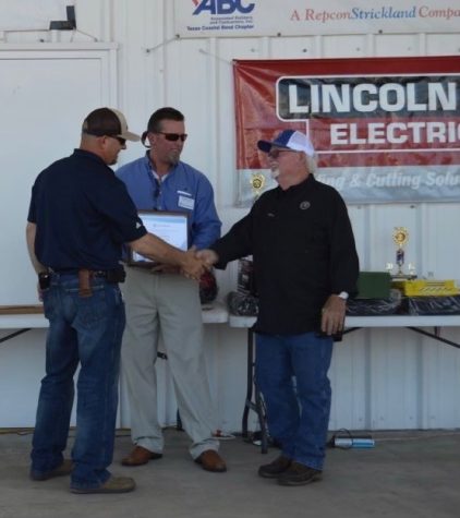 Randell Buttler accepts the Outstanding Welding Instructor Award at the Craft Training Center. 