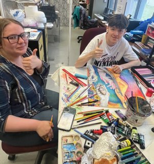 Santiago Chiang and Madison Gianotti working on their artwork